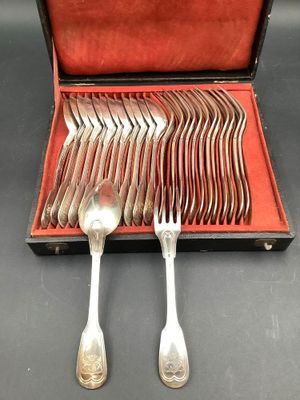 silverware in a case on a table with spoons and forks in it