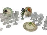 a lot of glasses and plates that are on the table