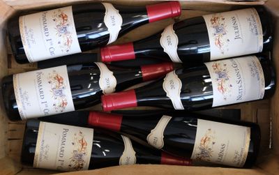 six bottles of wine in a cardboard box on the table