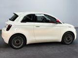 an image of a small white car in a showroom