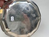 a person holding a silver plate with a tag on it