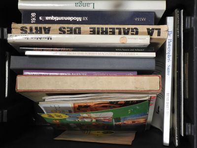 many books stacked on top of each other on a shelf