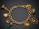 a close up of a gold bracelet with charms on it