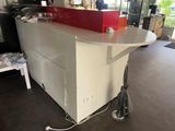 a white counter with a red laptop on it
