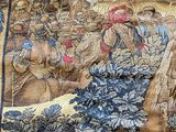 a very large tapestry with a picture of a man riding a horse