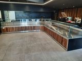 a glass display case in the middle of a kitchen