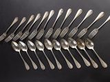 six spoons and six forks arranged in a row on a black surface