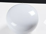 a white light bulb sitting on a white surface