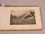 an old book with a picture of a mountain in the middle of it