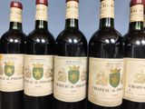 several bottles of wine are lined up on a table