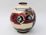a vase with a motorcycle painted on it on a white surface