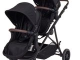 the stroller is black and has a brown handlebar