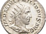 a silver coin with an image of a man wearing a crown
