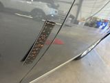 a measuring tape on the side of a car ' s door