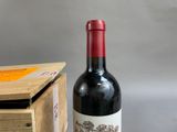 a bottle of wine sitting next to a wooden box