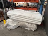 a pile of mattresses on a pallet in a warehouse