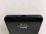 a close up of the back of a black cell phone