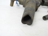 a pipe that is laying on the ground next to some other pipes