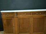 an old wooden sideboard with marble top on a wooden floor