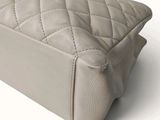 a close up of a purse on a white surface