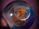 a glass object that is sitting on a purple surface