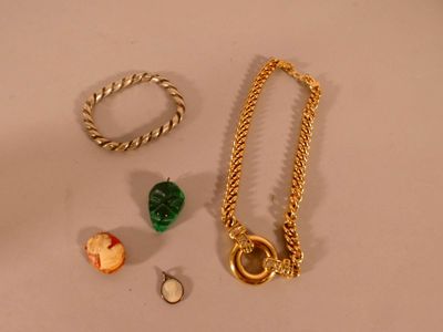 a necklace, bracelet, and ring laying on a table