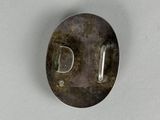 a close up of a metal object on a white surface