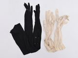 two pairs of gloves and a pair of gloves on a white surface