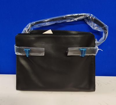 a black leather purse with a clear plastic handle