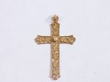 a close up of a gold cross on a white surface