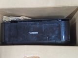 a canon printer sitting in a box on the floor