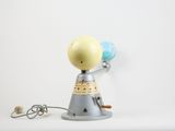a toy that is holding a globe on a stand