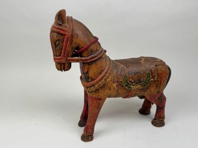 a small wooden horse with a bridle on it ' s head
