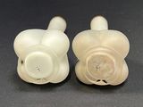 pair of white porcelain candlesticks with a carved design