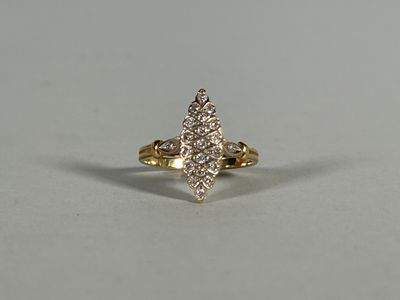 a yellow gold ring with diamonds on a white background