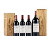 three bottles of red wine in front of a wooden box