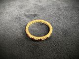 a close up of a gold ring on a black surface