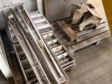 several pieces of metal are stacked on a pallet in a warehouse