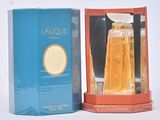 an image of a bottle of perfume sitting next to a box