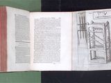 an open book with a drawing of a machine on it