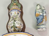 three pieces of pottery on the wall next to each other