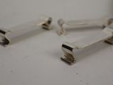 pair of silver plated metal handles on a white surface