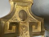 a gold clock sitting on top of a glass table