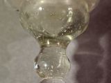 a glass vase sitting on a table next to a glass vase