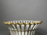 a white and gold bowl sitting on top of a table