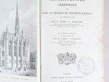 an open book with a drawing of a church in the background