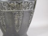 a large metal vase with a decorative design on it
