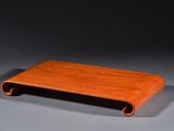 an image of a wooden tray on a table with a gray background