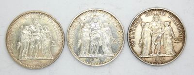three different types of silver coins are shown on a white surface