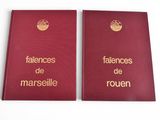 two red books with gold lettering on them sitting next to each other
